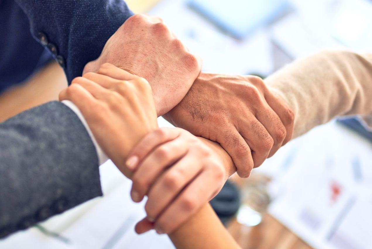 person in black long sleeve shirt holding persons hand